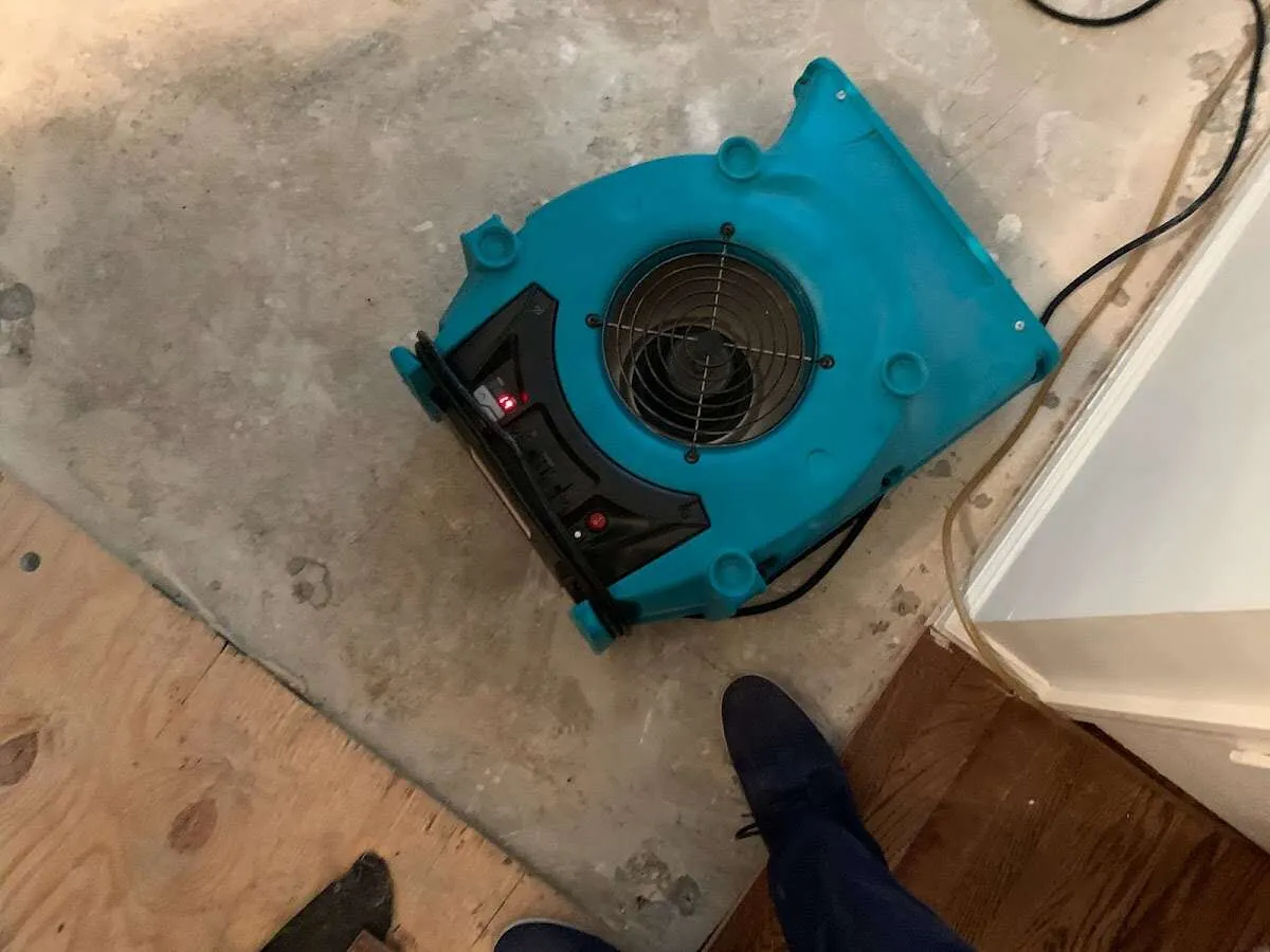 Air mover drying subfloor during Commercial Water Damage Restoration in Sacramento